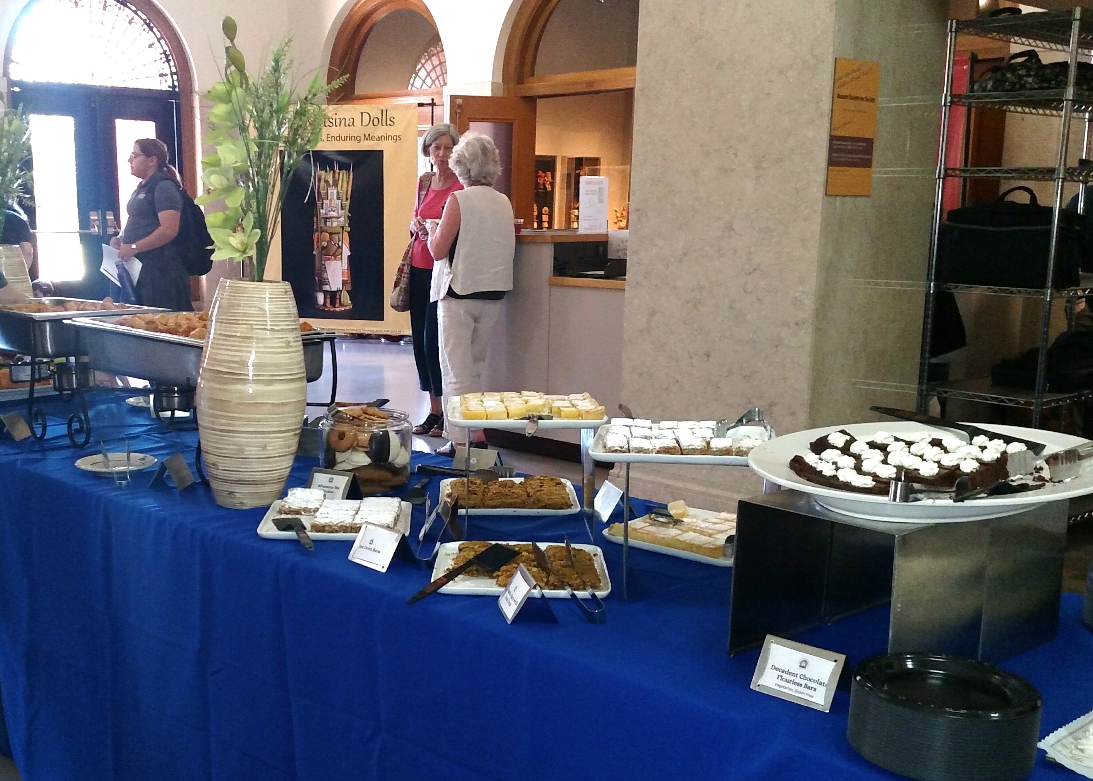 This image shows catered food displayed on a table with a blue tablecloth