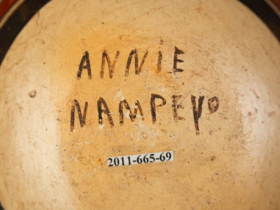 detail of 2011-665-69 showing Annie Nampeyo's signature on the bottom of the vessel