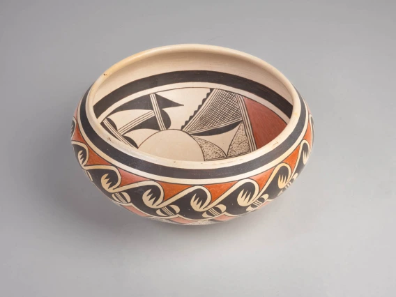 a polychrome bowl with avian designs on the interior and exterior