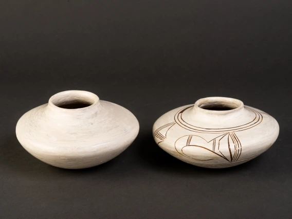 two ceramic vessels lined in a row, showing two stage of manufacture