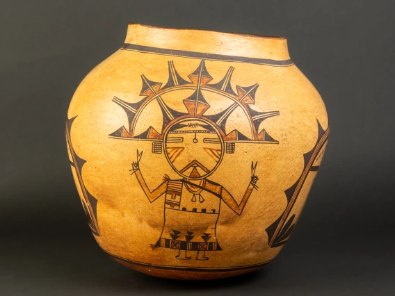 A large Hopi jar with polychrome katsina design painted on a field of yellow clay.