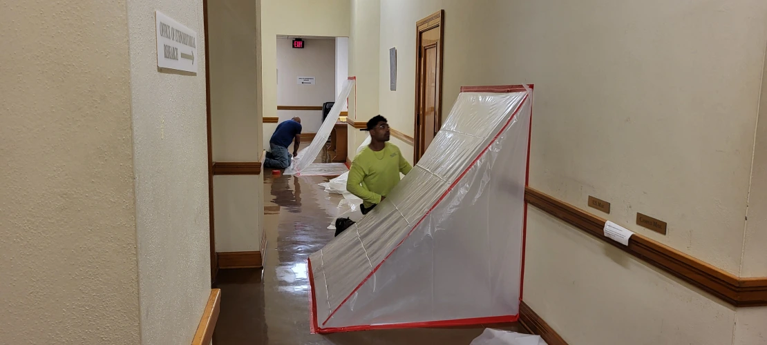 crews cut holes in the walls and cover them with plastic tents