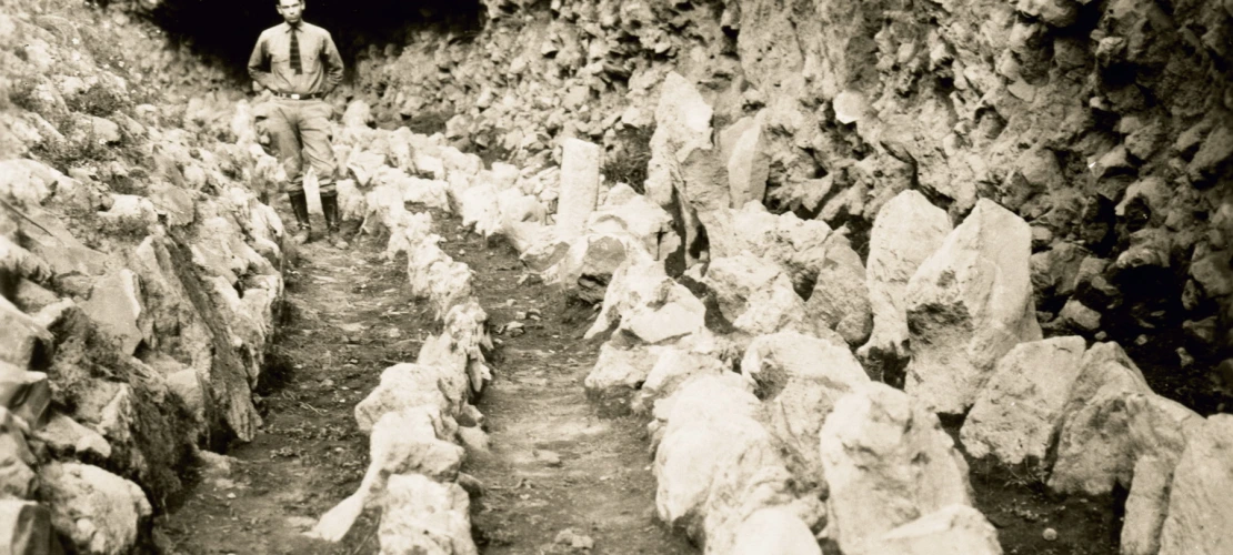 Emil Haury standing in part of the excavated site