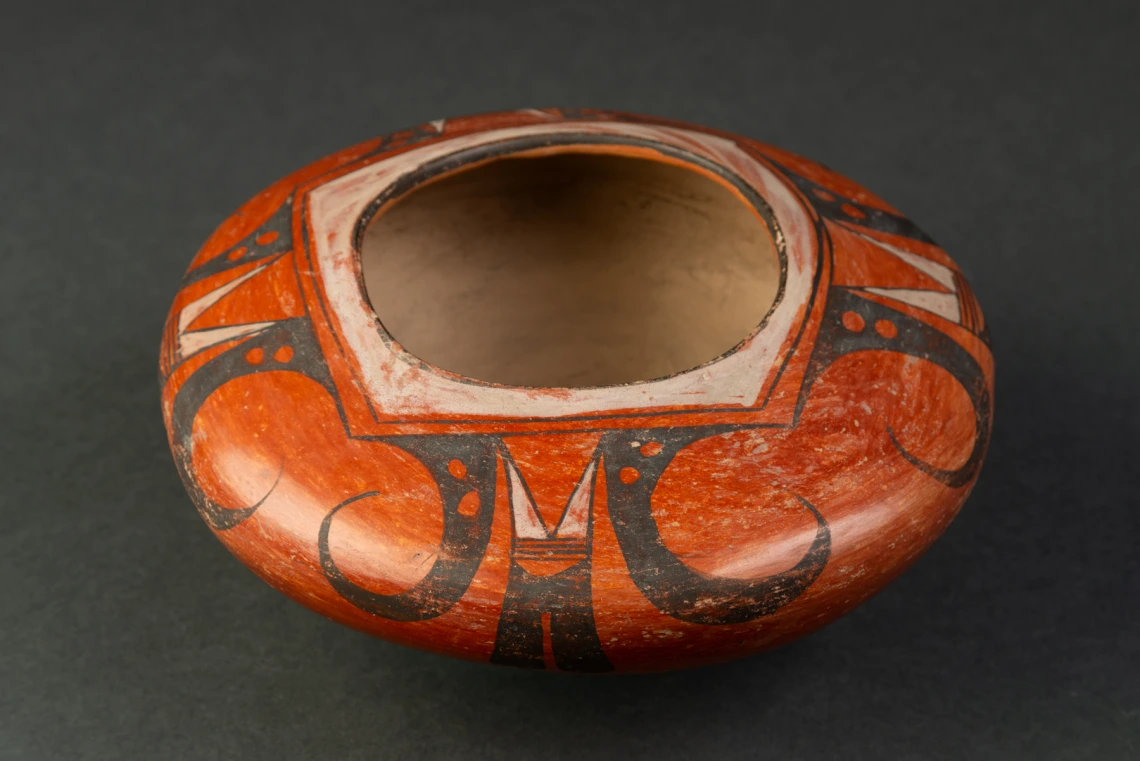 red-slipped polychrome jar with simplified eagle tail design