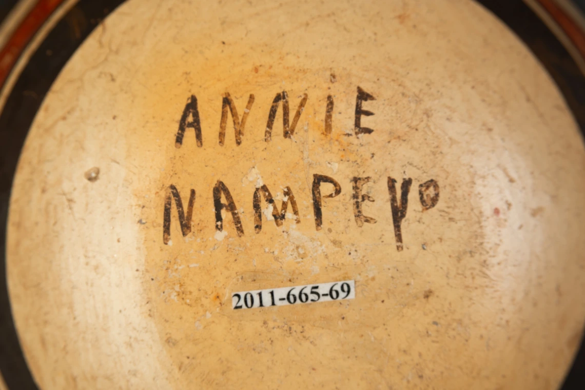 detail of 2011-665-69 showing Annie Nampeyo's signature on the bottom of the vessel