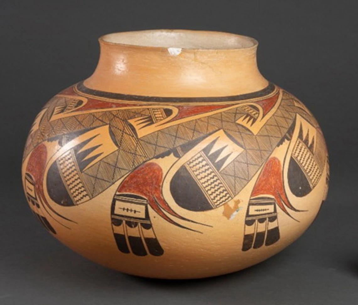 polychrome jar showing a chip on its lip