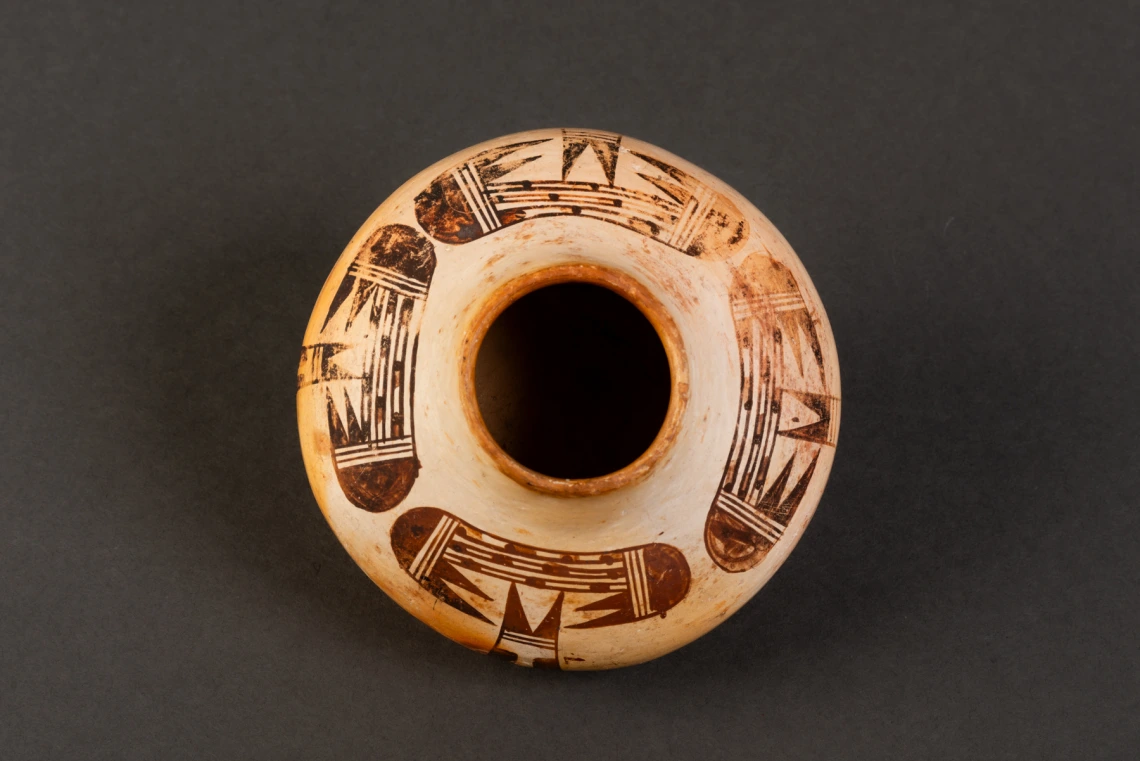 top view of 2018-6-210, small polychrome jar with bird-wing design