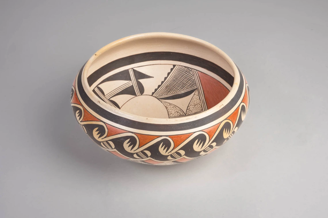 a polychrome bowl with avian designs on the interior and exterior