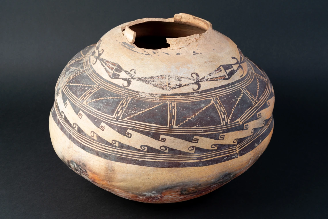 a Polacca polychrome jar showing constriction around body below the shoulder