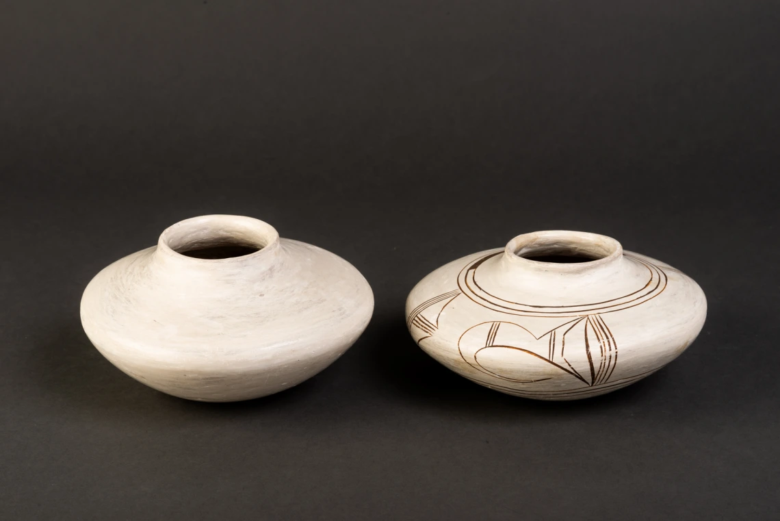 two ceramic vessels lined in a row, showing two stage of manufacture