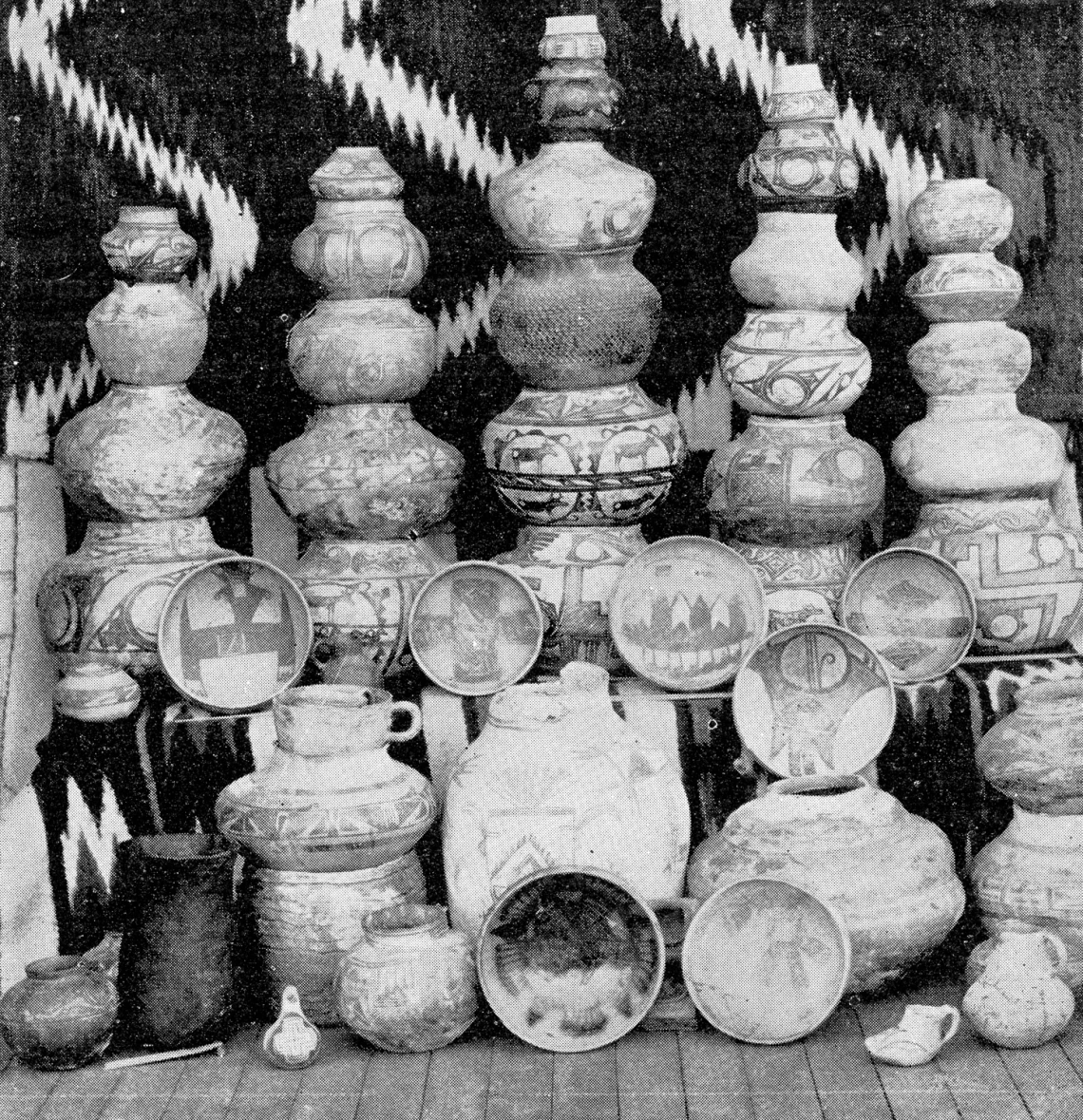 black and white image showing rows of pots, many stacked on each other