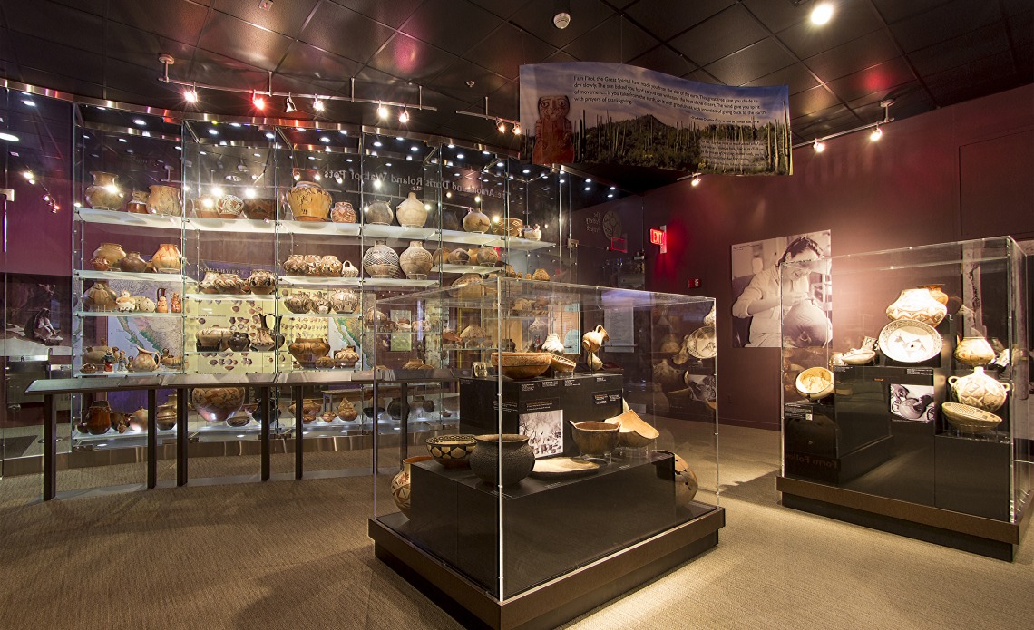 view of the pottery gallery display cases and the Wall of Pots.