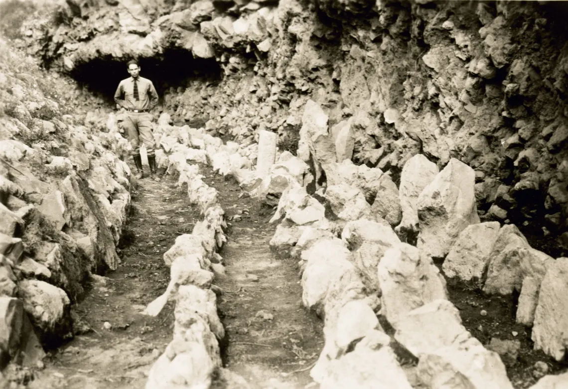 Emil Haury standing in part of the excavated site