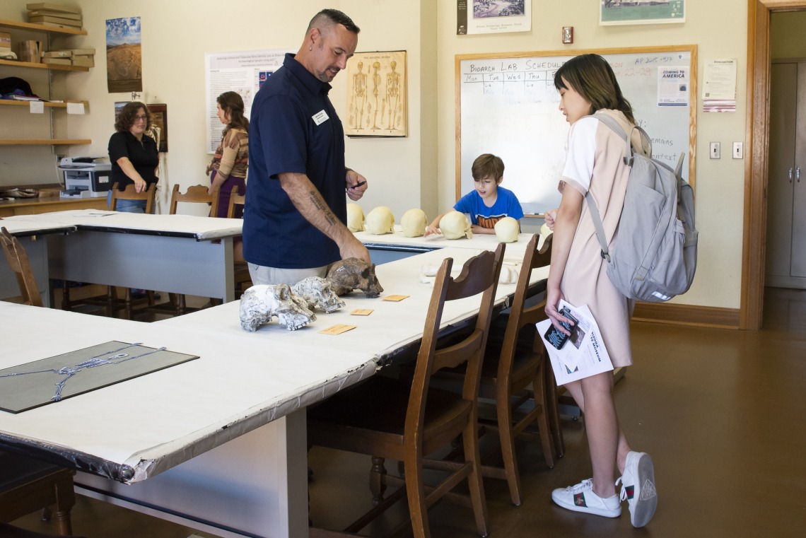 Associate Curator of Bioarchaeology Dr. James T. Watson welcomes students of all ages into ASM's human osteology laboratory (skulls shown are plastic models).