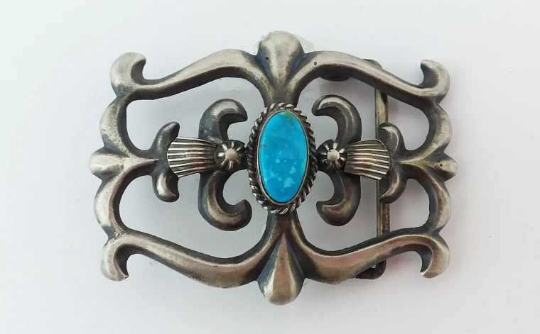 silver belt buckle with turquoise in center