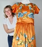 woman posing next to dress on mannequin