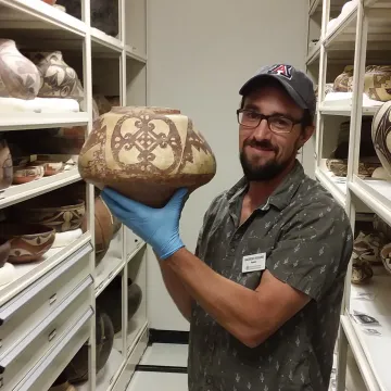 Registrar Andrew Higgins in the pottery vault.