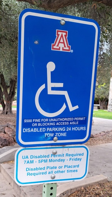 a blue and white handicapped parking sign