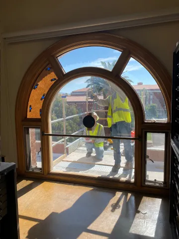 contractors inspecting windows in north building