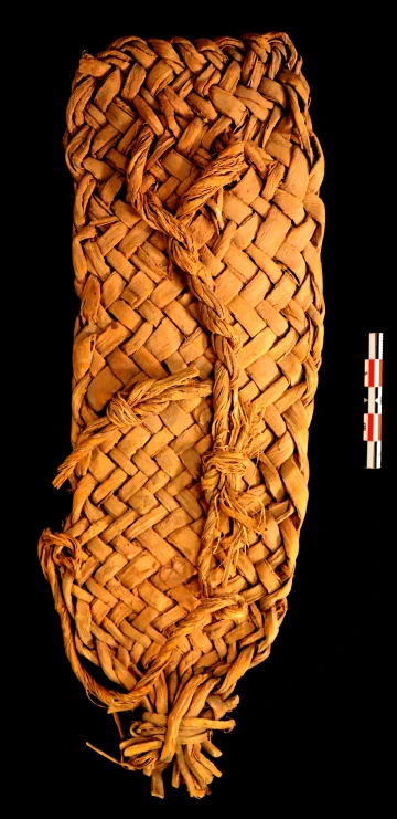 The sandal is not twined, instead it is made out of thicker yucca fibers that are braided together so the fibers cross over each other in a diagonal manner.