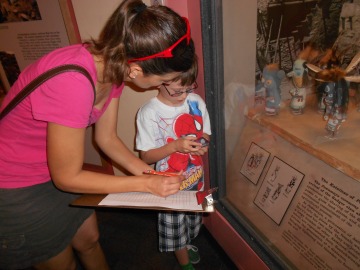 One Adult and child are viewing an exhibit together