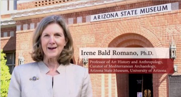 Dr. Irene Bald Romano in front of museum