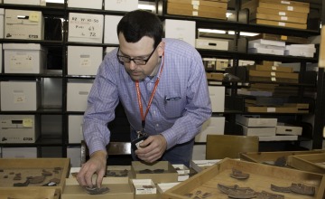 Dr. Patrick D. Lyons analyzes pottery from Point of Pines Pueblo (San Carlos Apache Reservation, southeast Arizona).